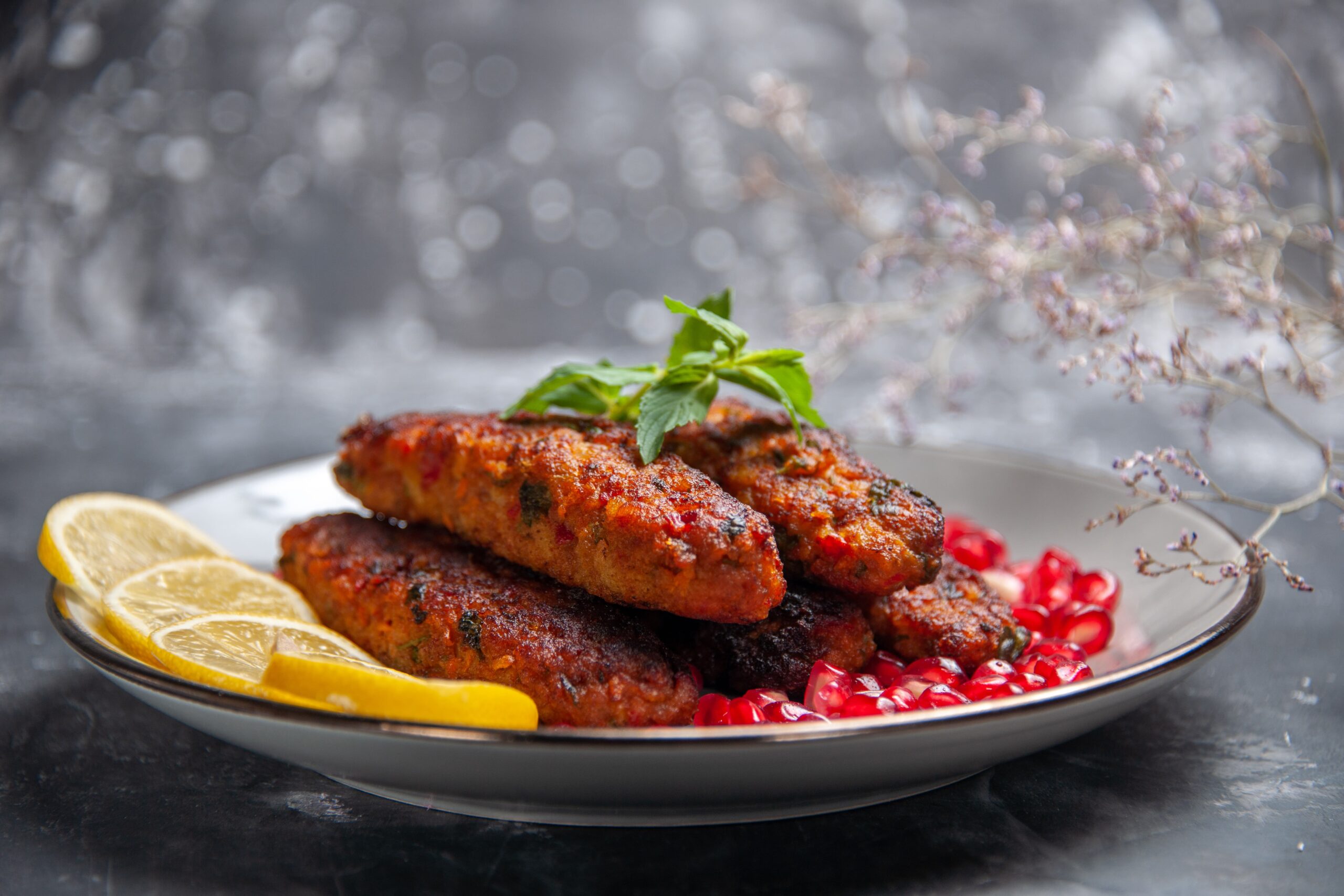 front-view-long-meat-cutlets-with-lemon-pomegranates (1)