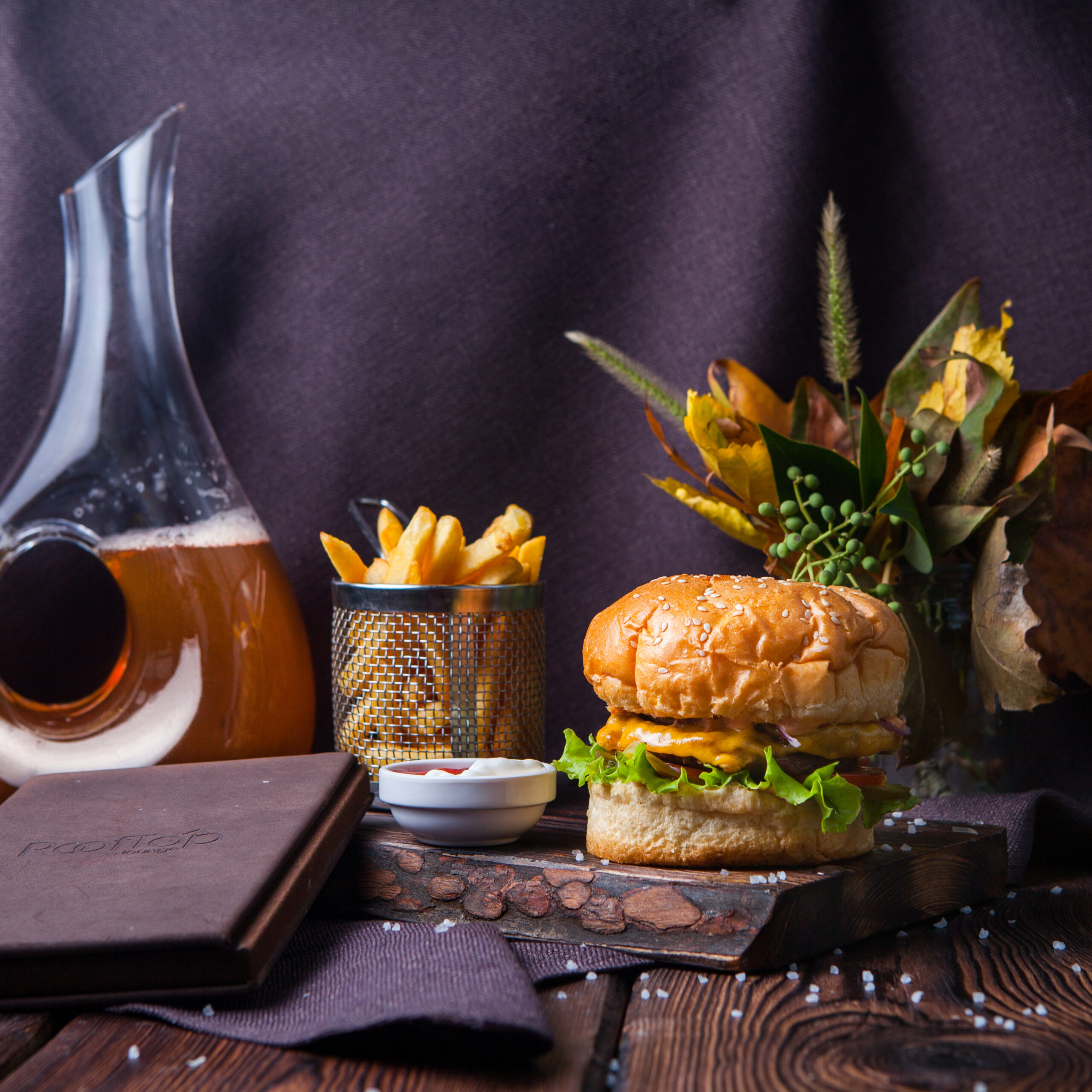 side view hamburger french fries wood black background with decorations scaled